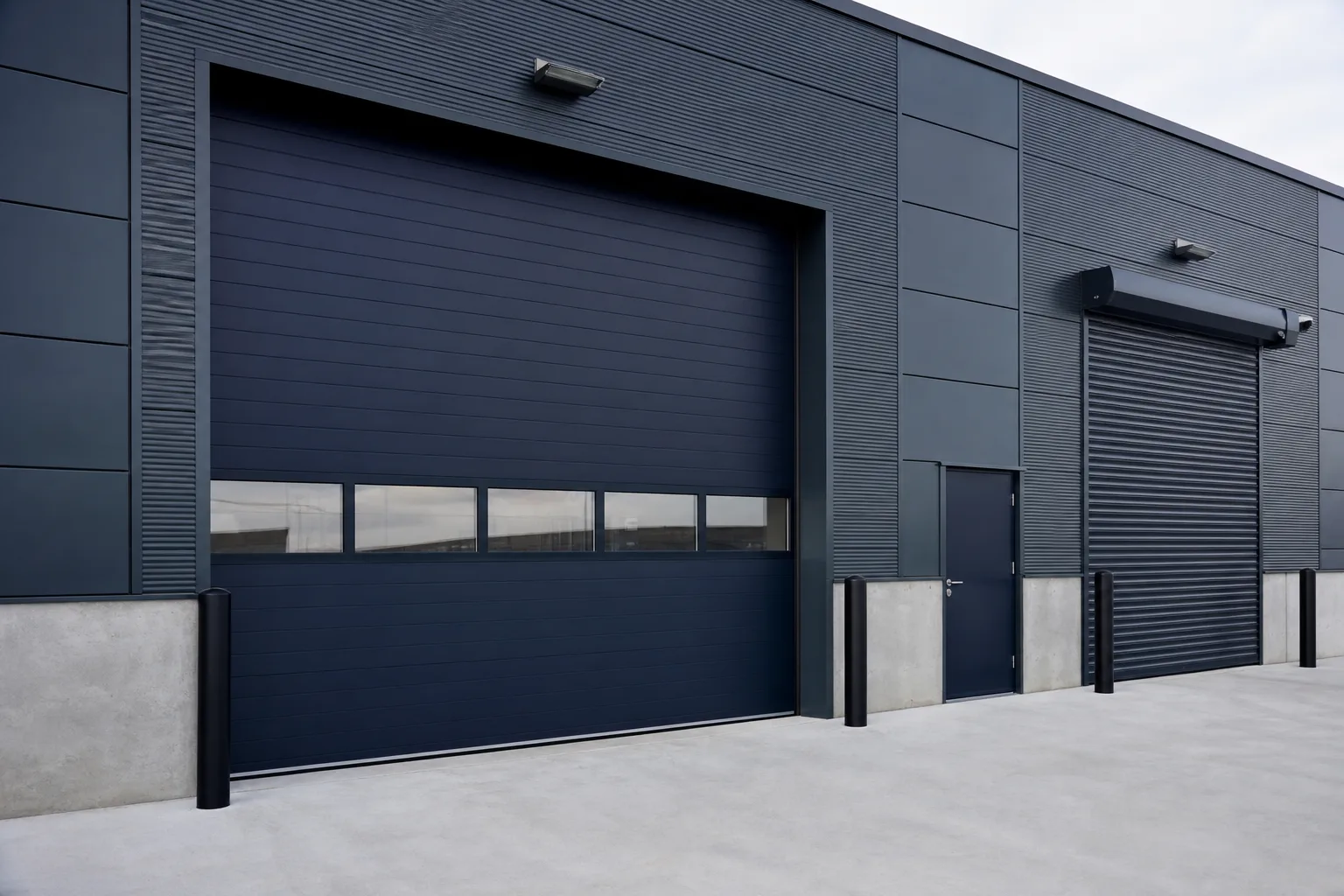 Industrial facility with heavy-duty rolling door systems