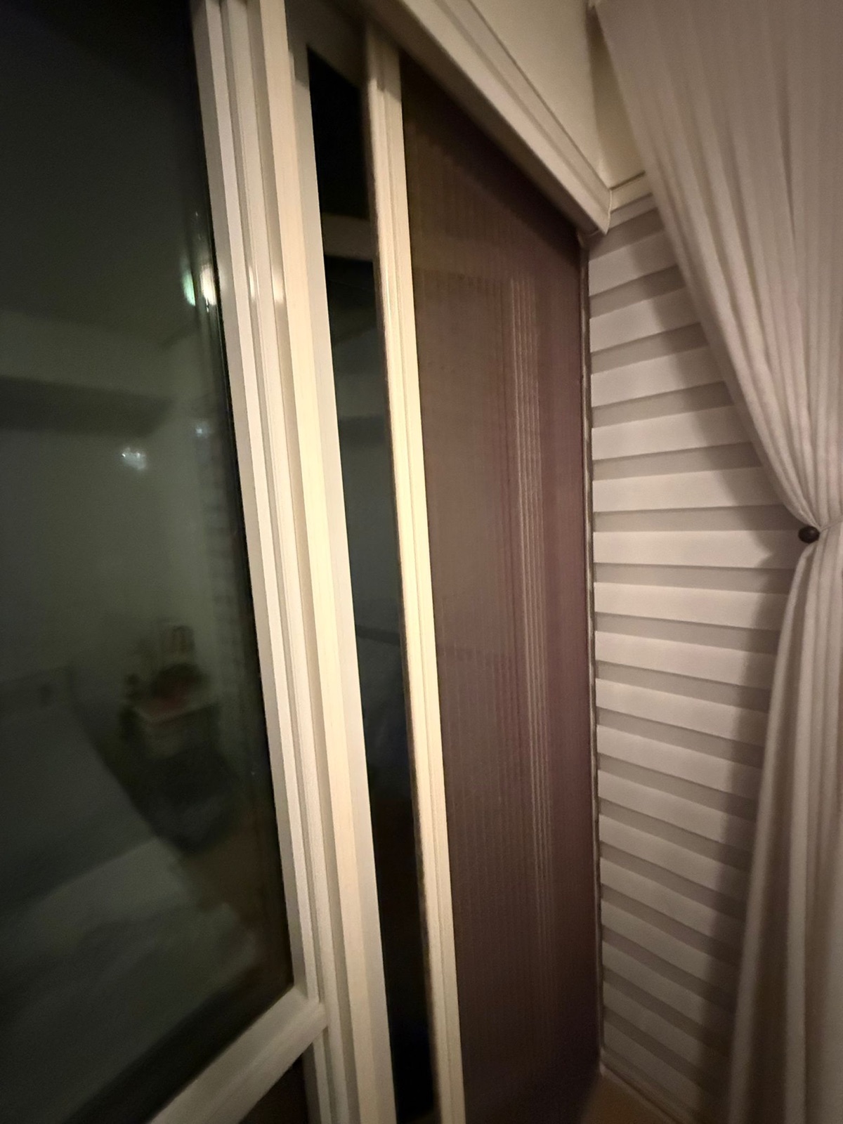Pleated retractable insect screen installed on a patio door, view 001